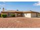 Single-story brick home features a two-car garage and low-maintenance desert landscaping in the front yard at 2541 E Inverness Ave, Mesa, AZ 85204