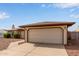 A two-car garage is attached to a cozy brick home with desert landscaping in the front yard at 2541 E Inverness Ave, Mesa, AZ 85204