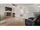 Spacious living room featuring a cozy brick fireplace and lots of natural light at 2541 E Inverness Ave, Mesa, AZ 85204