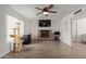 Spacious living room featuring a cozy brick fireplace and lots of natural light at 2541 E Inverness Ave, Mesa, AZ 85204