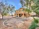 Expansive backyard featuring a covered patio, lush greenery, and a refreshing swimming pool at 25453 N 68Th Ln, Peoria, AZ 85383