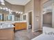 En-suite bathroom with a double sink vanity, a soaking tub, and a separate shower with tile floors at 25453 N 68Th Ln, Peoria, AZ 85383