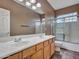 Bathroom featuring a double sink vanity, large mirror and shower-tub combo at 25453 N 68Th Ln, Peoria, AZ 85383