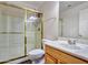 Bright bathroom features a stand-up shower with seamless glass door and gold trim at 25453 N 68Th Ln, Peoria, AZ 85383