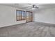 Spacious bedroom featuring plush carpet, ceiling fan, and plantation shutters at 25453 N 68Th Ln, Peoria, AZ 85383