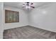 A carpeted spare bedroom with natural light coming through the shuttered window at 25453 N 68Th Ln, Peoria, AZ 85383