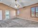 A simple and spacious bedroom offers a walk-in closet and plenty of natural light, carpet flooring at 25453 N 68Th Ln, Peoria, AZ 85383