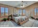 Comfortable bedroom featuring a ceiling fan, natural lighting, and stylish décor and furnishings at 25453 N 68Th Ln, Peoria, AZ 85383