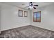 Neutral bedroom featuring three windows and a ceiling fan with light fixture at 25453 N 68Th Ln, Peoria, AZ 85383