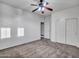 Neutral bedroom featuring a ceiling fan and closet with sliding doors at 25453 N 68Th Ln, Peoria, AZ 85383