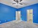 Bright blue bedroom featuring a ceiling fan and walk-in closet at 25453 N 68Th Ln, Peoria, AZ 85383
