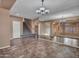 Bright dining room with unique chandelier and large mirror reflecting the adjacent living area at 25453 N 68Th Ln, Peoria, AZ 85383