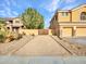 A long, gravel driveway leads to a gated area beside a well-maintained home with mature landscaping at 25453 N 68Th Ln, Peoria, AZ 85383