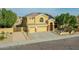 Two-story home featuring a three-car garage, desert landscaping, and solar panels on the roof at 25453 N 68Th Ln, Peoria, AZ 85383