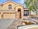 Welcoming home featuring a charming pond, mature shade trees, and a three-car garage at 25453 N 68Th Ln, Peoria, AZ 85383