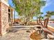 Beautiful front yard featuring desert landscaping, mature trees, and a decorative pond area at 25453 N 68Th Ln, Peoria, AZ 85383