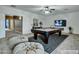Entertaining game room features a pool table, ceiling fan, and plush seating at 25453 N 68Th Ln, Peoria, AZ 85383