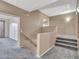 Spacious hallway with carpeted floor and staircase leading to the upper level and open room at 25453 N 68Th Ln, Peoria, AZ 85383