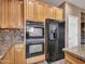 Kitchen showcasing stainless steel double ovens, a refrigerator, and wood cabinets at 25453 N 68Th Ln, Peoria, AZ 85383