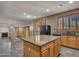 Open kitchen with center island, granite counters, and wood cabinets with tile flooring at 25453 N 68Th Ln, Peoria, AZ 85383