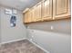 Functional laundry room with upper cabinets and ample space for appliances at 25453 N 68Th Ln, Peoria, AZ 85383