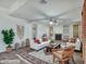 Bright living room features modern decor, stylish furnishings, and a cozy fireplace at 25453 N 68Th Ln, Peoria, AZ 85383