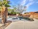 Sparkling in-ground pool is surrounded by lush landscaping and hardscape in the backyard at 25453 N 68Th Ln, Peoria, AZ 85383