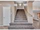 A well-lit staircase features neutral carpet, leading to the upper level of the home at 25453 N 68Th Ln, Peoria, AZ 85383