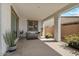 Cozy covered patio with a comfortable seating area and various potted plants on a concrete slab at 25800 N 140Th Ln, Surprise, AZ 85387