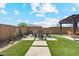 Backyard featuring an outdoor seating area with low-maintenance landscaping and a desert aesthetic at 25800 N 140Th Ln, Surprise, AZ 85387