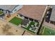 Aerial view of the backyard featuring desert landscaping, a pergola, a sitting area, and a well maintained lawn at 25800 N 140Th Ln, Surprise, AZ 85387