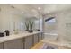 Bathroom features a freestanding tub, elegant vanity, and modern finishes for a spa-like feel at 25800 N 140Th Ln, Surprise, AZ 85387