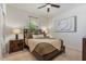 Cozy bedroom with a queen bed, decorative pillows, and bedside lamps at 25800 N 140Th Ln, Surprise, AZ 85387