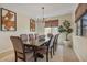 Traditional dining room featuring a large wooden table, upholstered chairs, and natural light from a window at 25800 N 140Th Ln, Surprise, AZ 85387