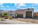 Charming single-story home featuring a tile roof, arched entryway, desert landscaping, and a three car garage at 25800 N 140Th Ln, Surprise, AZ 85387