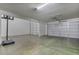 Spacious three-car garage with plenty of room for vehicles and storage on a concrete floor at 25800 N 140Th Ln, Surprise, AZ 85387