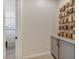 Hallway features unique decorative wall art and grey storage cabinets creating a sleek look at 25800 N 140Th Ln, Surprise, AZ 85387