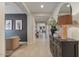 Inviting entryway featuring neutral walls, wood-look tile flooring, and stylish decor, complemented by natural light and an open layout at 25800 N 140Th Ln, Surprise, AZ 85387