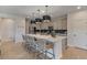 Beautiful kitchen with a spacious island, pendant lighting, stainless steel appliances, and modern bar stool seating at 25800 N 140Th Ln, Surprise, AZ 85387