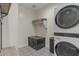 Well-organized laundry room featuring modern appliances and a patterned tile floor at 25800 N 140Th Ln, Surprise, AZ 85387