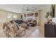 Relaxing living room featuring natural light, wood-look tile flooring, a ceiling fan, comfortable seating, and neutral tones at 25800 N 140Th Ln, Surprise, AZ 85387