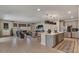 Open concept living and kitchen area featuring an island with seating and a comfortable living space with a large sofa at 25800 N 140Th Ln, Surprise, AZ 85387