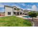 Expansive backyard showcasing lush lawn, sparkling pool, and covered patio of the home at 30246 N 123Rd Ln, Peoria, AZ 85383