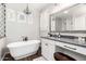 Elegant bathroom with a soaking tub, chandelier, and high-end finishes, offering a luxurious spa-like experience at 30246 N 123Rd Ln, Peoria, AZ 85383