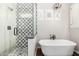 Beautiful bathroom featuring a soaking tub, chandelier, glass shower, and modern fixtures with beautiful designs at 30246 N 123Rd Ln, Peoria, AZ 85383