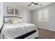 Bedroom featuring a ceiling fan, plantation shutters, a bed with a decorative headboard at 30246 N 123Rd Ln, Peoria, AZ 85383