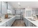 Updated kitchen featuring grey cabinets, stainless steel appliances, quartz countertops, and a tile backsplash at 30246 N 123Rd Ln, Peoria, AZ 85383