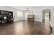 Bright living room with wood floors, shuttered windows, a grand piano, and access to a pool area at 30246 N 123Rd Ln, Peoria, AZ 85383