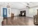 Spacious living room showcasing wood floors, plantation shutters, an office area, and a blue door at 30246 N 123Rd Ln, Peoria, AZ 85383