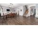 Spacious dining and living area with a staircase, modern lighting, and wood floors at 30246 N 123Rd Ln, Peoria, AZ 85383